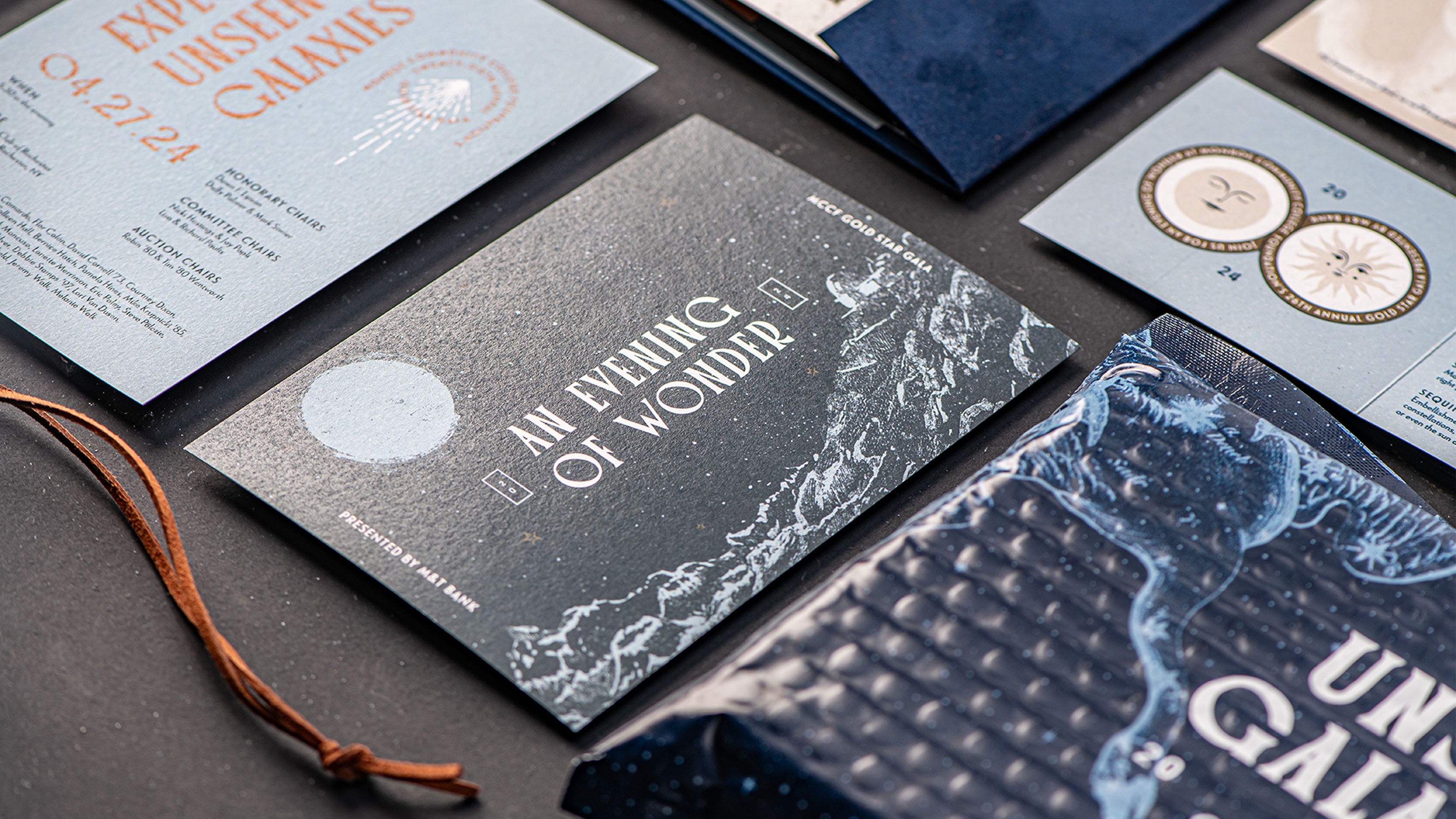 Printed contents of the 2024 Monroe Community College Foundation Gold Star Gala invitation arranged in grid